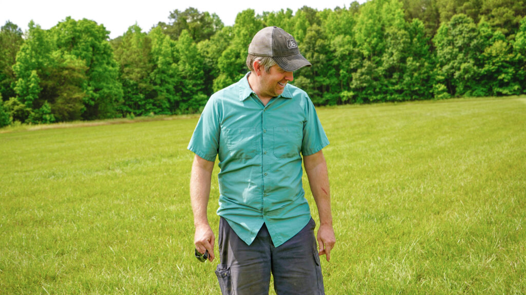 Matt Davis walking in his hay field in North Carolina